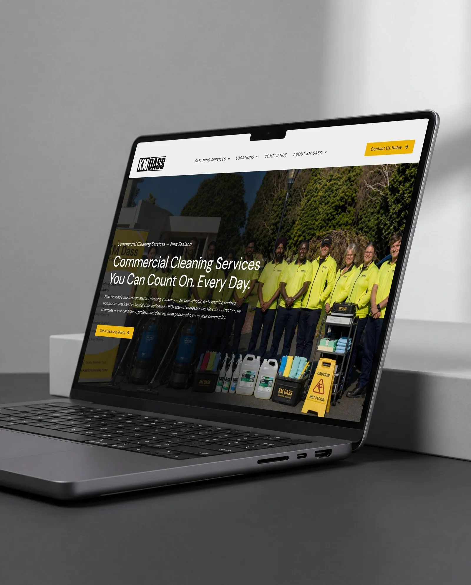 KM Dass Cleaning homepage shown on a laptop