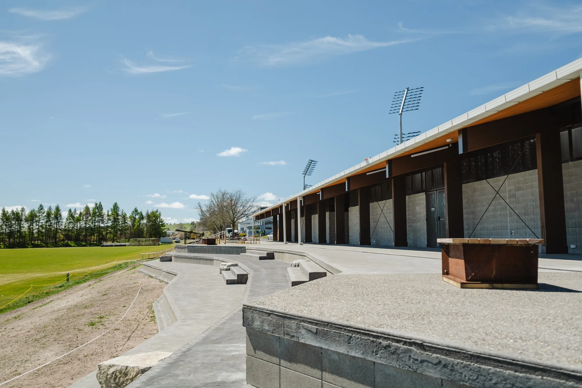 Terraced concrete seating along a sports pavilion, poured by Wise Concrete Taupō